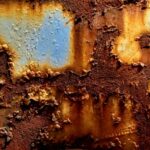 Corrosion on surface with blue and yellow paint